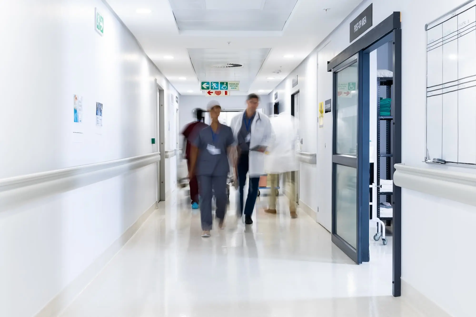 Doctors and nurses walking down hallway